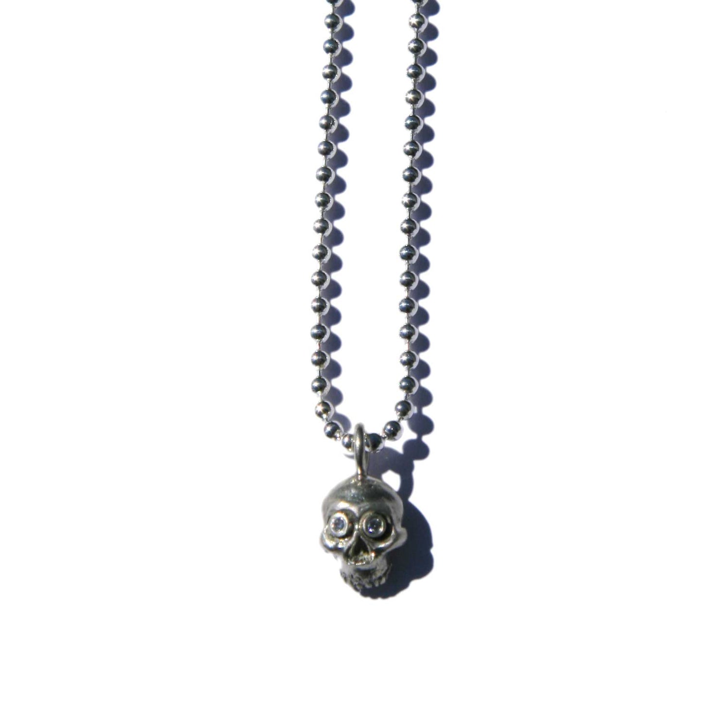 Tiny skull necklace with diamond eyes