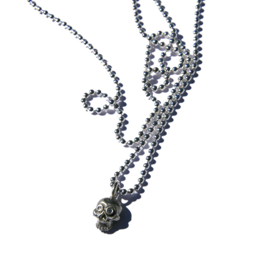 Tiny skull necklace with diamond eyes